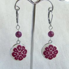 Hand embroidered earrings for women. The embroidery is a beautiful purple flower from the traditional Romanian embroidery. I also added a semi-precious stone bead, a purple regalite for a perfect bohemian lookTotal length: 4.8 cmRegalite beads: 6 mmEmbroidery size: 1.6 cm Your jewelry comes in a beautiful gift box which means it is ready for gift giving.Although I make every effort to photograph items accurately, I cannot guarantee every computer monitor will accurately depict the actual colors. Purple Traditional Earrings For Gift, Elegant Embroidered Festive Jewelry, Elegant Embroidered Jewelry For Festive Occasions, Purple Beaded Earrings As Gift, Purple Beaded Round Earrings For Gift, Purple Round Beaded Earrings For Gift, Traditional Embroidered Drop Earrings, Traditional Embroidered Jewelry For Gifts, Handmade Purple Earrings For Her