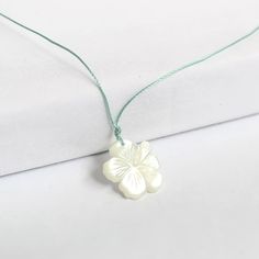 Carved Hibiscus Necklace – Leighton Lam Designs White Flower Charm Necklace For Beach, White Shell-shaped Necklace For Gift, White Flower Charm Necklace For The Beach, White Shell-shaped Necklace For A Gift, White Shell Necklace With Pearl Pendant As Gift, White Flower Pendant Jewelry For Beach, White Mother Of Pearl Pendant Shell Necklace, White Mother Of Pearl Jewelry With Flower Charm, White Mother Of Pearl Pendant Necklace