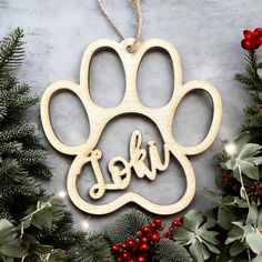 a wooden ornament with the word dog written on it and a paw print