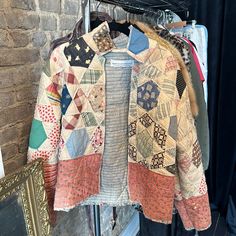 a jacket hanging on a rack next to a brick wall