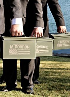 two men in suits are holding boxes with the words m gordon and ammons on them