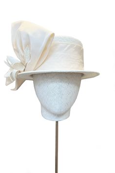 The Orchid Boater is a sensational new piece of sustainable millinery for this season. A statement couture straw hat, made of Panama straw that has been hand woven in Ecuador. It is trimmed with structured silk bow and flower detail. It has a soft elasticated inner ribbon for a comfortable fit. Team with our beautiful Layla Jacket and Zelda Skirt in Cream Tweed to create the most sensational modern occasion wear look. Perfect for Royal Ascot and special summer weddings. Designed in collaboration Suzannah London, London Boutique, Women Hats, Boutique Couture, The Orchid, Elegant Hats, Silk Bow, Formal Dresses Gowns, Natural Edge