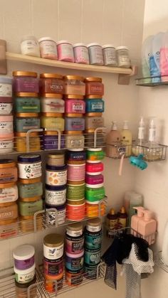 the shelves are filled with many different types of jars and containers, all stacked on top of each other