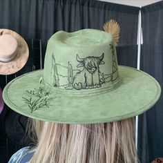 Y’all, this isn’t just hat art—it’s a whole mood. 🤠🌿 Hand-burned with love, this green suede fedora brings the charm of rustic ranch vibes to life. That Highland cow? Total scene-stealer. Did you know we have never been able to keep a Highland cow on the shelves long after it's burned? They always sell as soon as we put them out! And we've burned quite a few!🐂🔥 Who’s ready to make a statement with a little wild west flair? #HandBurnedHats #WesternChic #SouthwestStyle #HatTattCo Ranch Vibes, Hat Art, Scene Stealer, Hand Burn, Western Chic, Southwest Style, Green Suede, Curvy Girl Outfits, Highland Cow