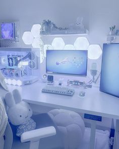 a white desk topped with a computer monitor and keyboard