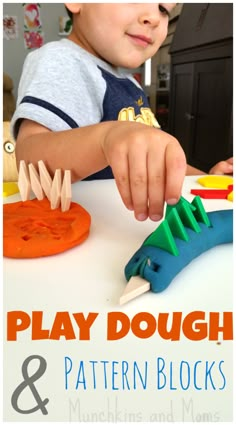 a young boy is playing with plastic dinosaurs and blocks to make them look like alligators