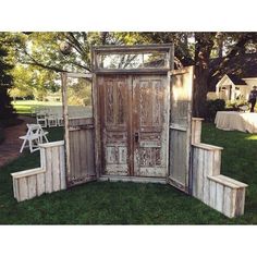 an old wooden door sitting in the grass