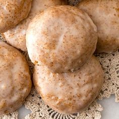 several donuts are sitting on a doily with brown sugar sprinkles