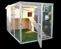 an outdoor chicken coop with stairs and grass