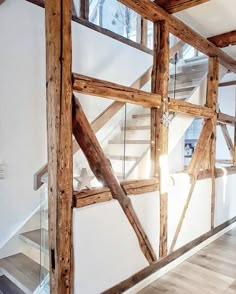 the inside of a building with wooden beams