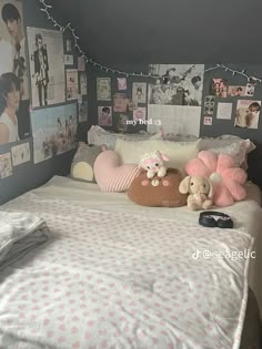 a bed with pictures on the wall and stuffed animals