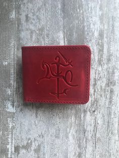 100 % full-grain handmade leather wallet. Slim and small red bifold wallet for men. Precisely made from high quality cow leather. Lasts for years, therefore is a perfect gift. The wallet is engraved with an ancient stylized coat of arms of Lithuania. Wallet is made from full grain cow leather. Crazy horse is a specially processed leather type that gives it an antique appearance. This type of leather is long lasting, very durable and any scratches or rubs turn it to a different shade, bend line a Red Trifold Wallet With Coin Pocket For Daily Use, Red Rectangular Trifold Wallet For Daily Use, Red Bifold Wallet For Everyday Use, Red Trifold Rectangular Wallet, Red Trifold Wallet With Card Slots, Red Rfid Blocking Trifold Wallet, Red Trifold Wallet For Daily Use, Red Bifold Card Holder, Red Bifold Card Holder With Interior Slots