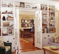 a living room filled with furniture and bookshelves