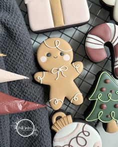 decorated cookies are sitting on a wire rack with other decorations and items in the background