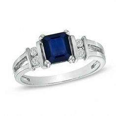 a blue sapphire and diamond ring on a white background