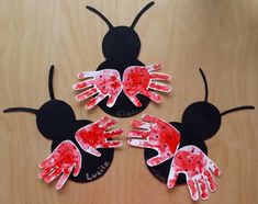 three handprinted mickey mouses on top of a wooden table