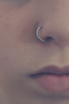 a woman's nose with a silver nose ring