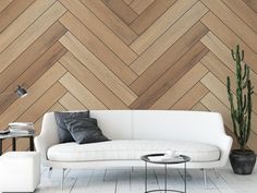 a white couch sitting in front of a wooden wall