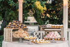 a table topped with lots of desserts and pastries