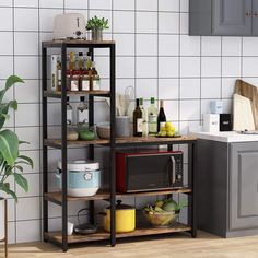 a kitchen area with a microwave, potted plant and other items on the shelves