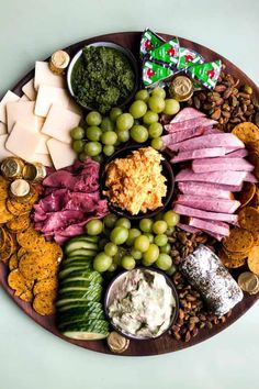 a platter filled with cheese, crackers and meats