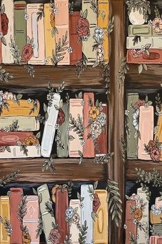 the books are lined up on the wooden shelves with flowers and leaves painted on them