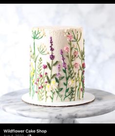 a white cake with flowers painted on it