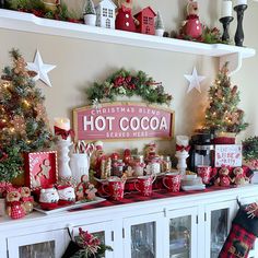 christmas decorations are displayed on the mantle in this living room, including stockings and hot cocoa