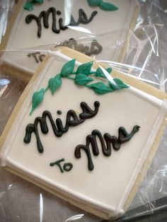 three decorated cookies sitting on top of plastic wrap