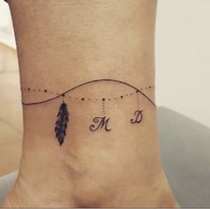 a woman's foot with an arrow and name tattoo on the side of her ankle