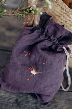 a purple bag with embroidered birds on it