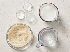 the ingredients for making rice are shown in small glass bowls on a white countertop