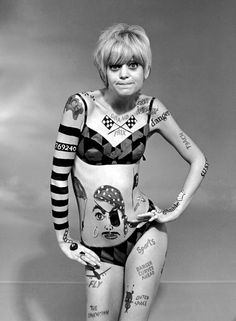 an autographed photo of a woman with tattoos on her arms and chest, in black and white