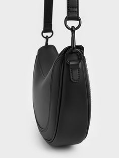 If you are looking for a silhouette that is slightly out of the ordinary, then this jet black saddle bag makes for a bold and unexpected choice. It features an asymmetrical curved silhouette, adding stylish structure to any look. Not any less functional, this piece is adequately sized to fit your daily essentials. It also comes with a detachable shoulder strap that allows you to use this piece as a crossbody bag. Black Saddle Bag, Black Saddle, Size Chart For Kids, Charles Keith, Shoe Gifts, Saddle Bag, Daily Essentials, Clothes Gift, Kids Bags