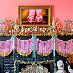 a fireplace decorated with pink and gold decorations