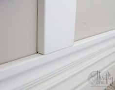 the corner of a wall with white paint and molding on it's edges