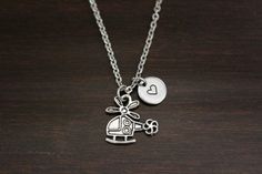 "This necklace includes a helicopter charm, choice of a bead, initial or stamped heart and a chain. Please leave in checkout notes: -Bead # (if chosen option) -Initial (if chosen option) -Length of chain: 18\", 20\", 22\" or 24\" Please choose chain from drop down box. C3-Stainless Steel 3mmx2.5mm Cable Chain-Small Link (Common Size) C4-Stainless Steel Ball Chain-Common C5-Stainless Steel Ball Chain-Fancy **I love creating custom orders. Please contact me if there is something you like and want Airplane Necklace, Helicopter Pilot, Helicopter Pilots, Pilot Gifts, Beads Pictures, Ribbon Necklace, Military Wife, Wife Gift, White Beads