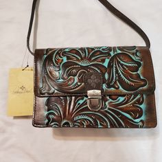 Patricia Nash Genuine Leather Tooled Turquoise Crossbody Locri. Turquoise Hand Tooled Rectangular Shoulder Bag, Hand Tooled Blue Crossbody Bag, Hand-tooled Blue Crossbody Shoulder Bag, Blue Hand Tooled Rectangular Shoulder Bag, Blue Rectangular Hand Tooled Shoulder Bag, Blue Hand Tooled Bags For Daily Use, Turquoise Hand Tooled Bag, Hand Tooled Blue Bags For Daily Use, Hand Tooled Blue Bag For Daily Use