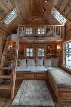 a living room with wooden walls and stairs leading up to the second story bed area