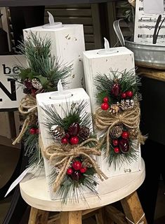 some white bags with red berries and pine cones tied to them are sitting on a table