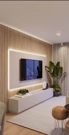 a living room filled with furniture and a flat screen tv mounted to the wall above it