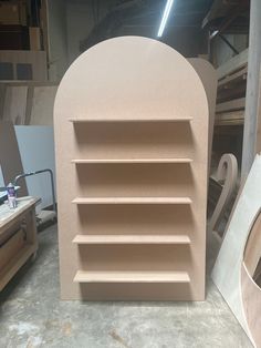 a close up of a wooden shelf in a room with other woodworking tools and materials