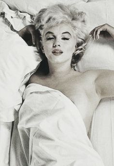 black and white photograph of marilyn monroe laying in bed