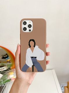 a person holding up a phone case with an image of elvis presley on it