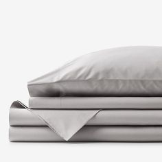 the sheets and pillow cases are stacked on top of each other, with one folded down