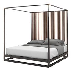 a bed with a metal frame and pillows