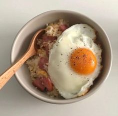 an egg is on top of rice in a bowl