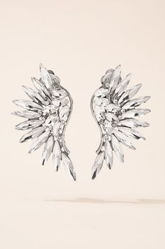 Spread your wings with these Phoenix wing clip earrings! Style these "wings" with that fancy dress you've been wanting to put on. Earring designed in an angel wing style that curve with the corresponding sides of your face. Simple yet elegant, beautifully designed fashion statement jewelry that goes well with any wardrobe. Size• Clip-on earrings.• Length: 2.25 in (5.72 cm)• Width: 1.25 in (3.18 cm) Quality Made of brilliant bright sparkling green rainbow rhinestones in a colorful paved setting o Angel Wings Winged Jewelry For Party, Angel Wings Jewelry For Party, Wing-shaped Earrings For Party, Phoenix Wings, Illusions Art, Green Rainbow, Small Boutiques, Optical Illusions Art, Pearl Shop