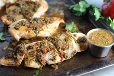 grilled chicken with herbs and sauce on a tray