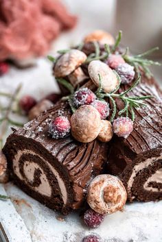 a chocolate roll with cranberries and powdered sugar on top